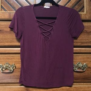 maroon v neck top with crosses on the chest